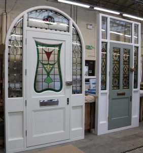 White timber front doors with stained glass