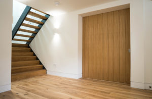 wooden panel door and open staircase