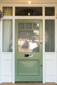 green front door with square windows