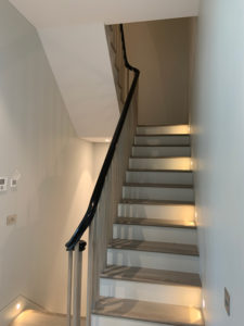 light grey staircase with black bannister