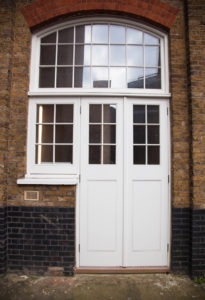 white large door with arch window and side window