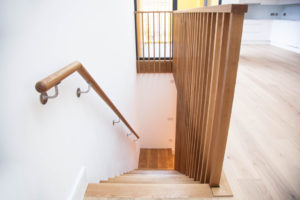 wooden staircase with wooden plank bannister