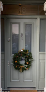 green grey door with christmas wreath