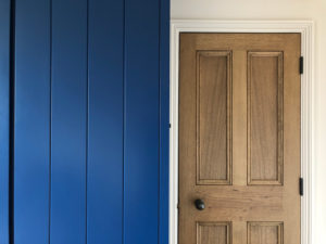 wood door next to blue wardrobe