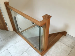 wooden hand rail bannister with glass pannels