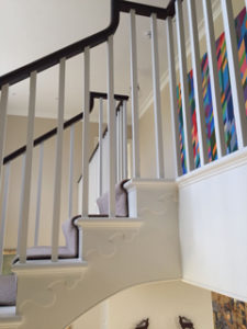 white open staircase with landing and black banister
