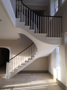 white open staircase with landing and black bannister