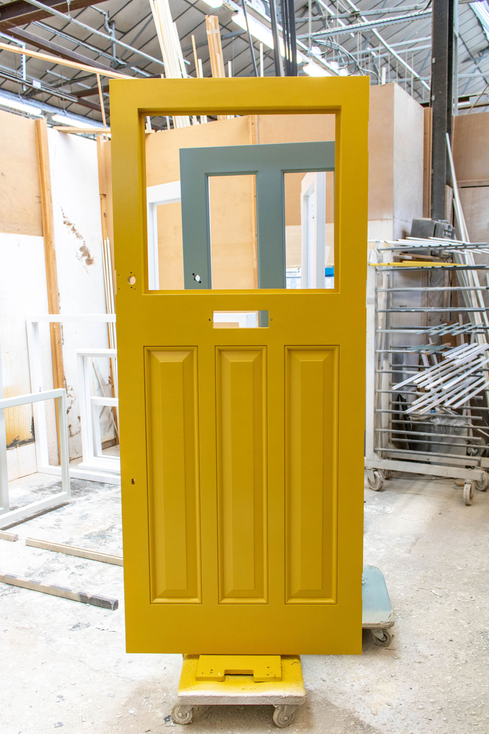 yellow door with glass panel in construction