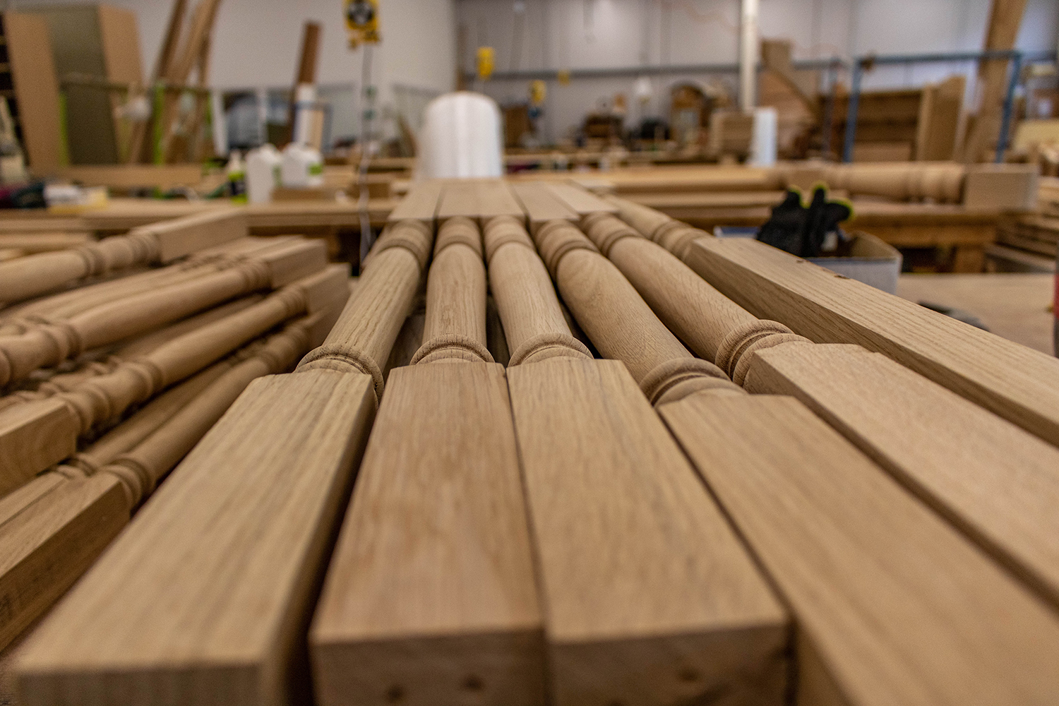 Stack of wood banister railings in workshop
