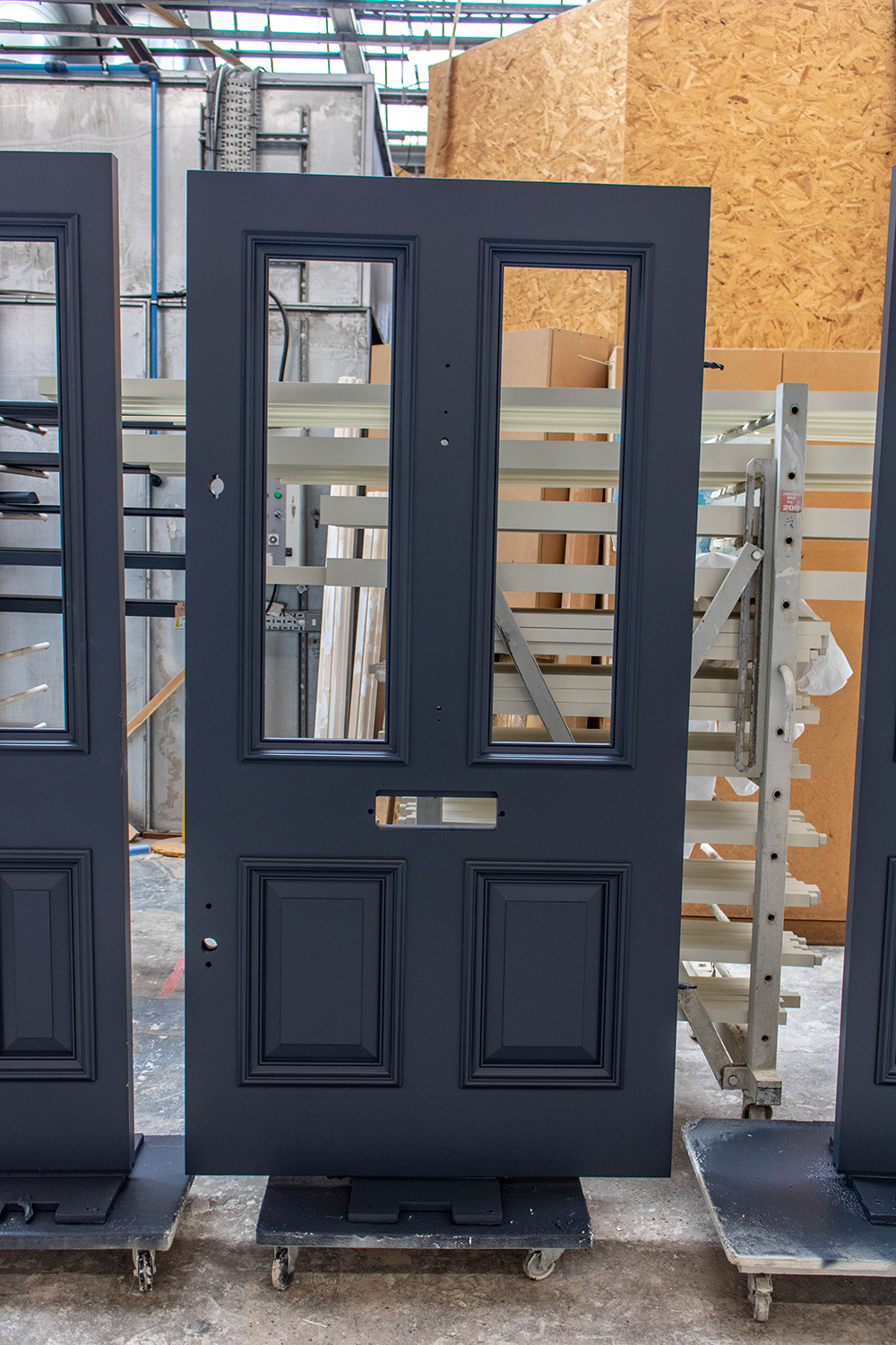 Construction of grey wooden door in joinery workshop