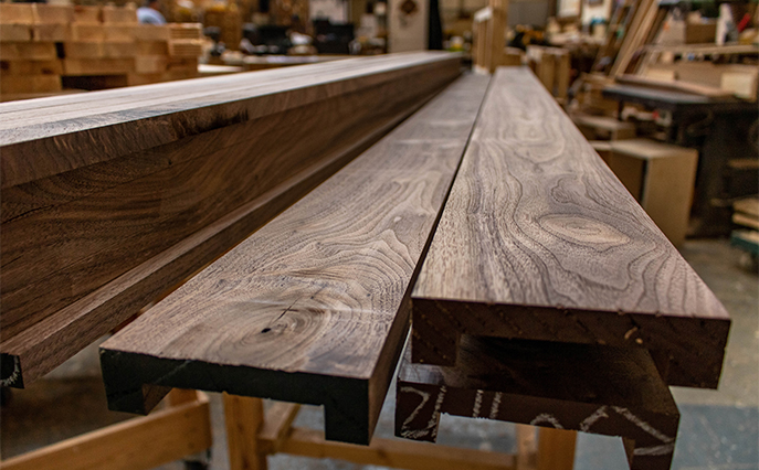 2 cut planks of dark wood